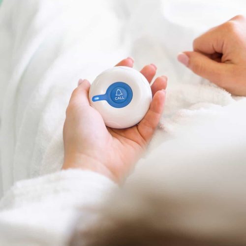 finger pressing the emergency call button in a medical clinic a patient calls a nurse for help